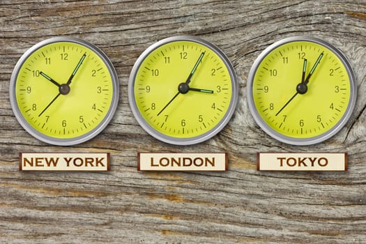 World time. Time in  New York, London and Tokyo, three watches on wooden wall