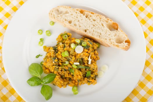 Lentil salad on white plate with white bread