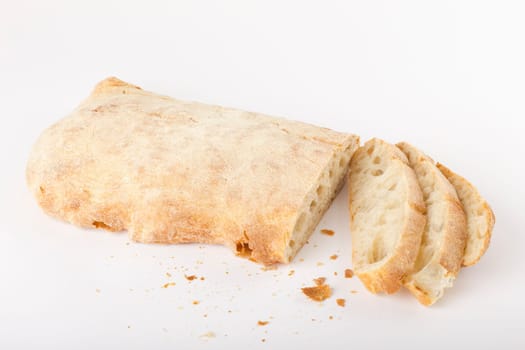 A sliced ciabatta bread on a white background