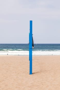 volleyball post at the beach in blue
