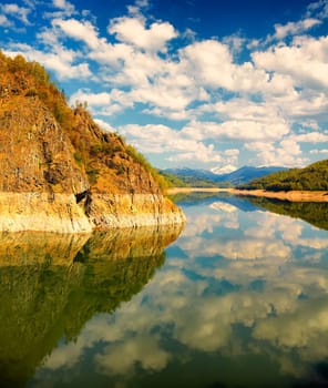 Beautiful landscape of Vidraru lake on a very peaceful day, Romania.