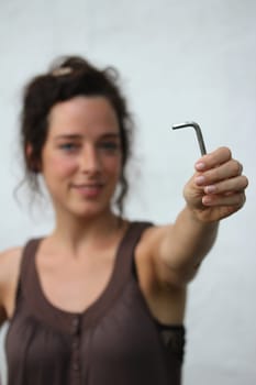 young woman holding an allen key