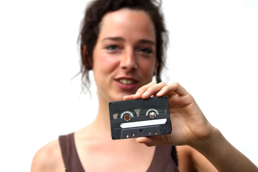 young woman holding a plain cassette