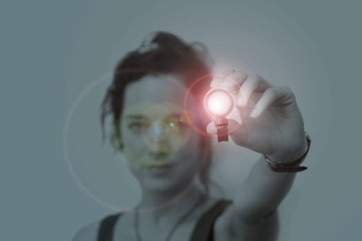 young woman holding a led flashlight at night