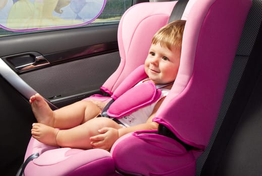 baby in a safety car seat. Safety and security