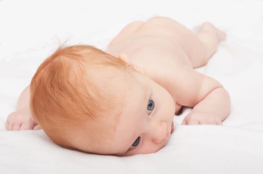 Cute Naked Red Haired Baby Lying on Front