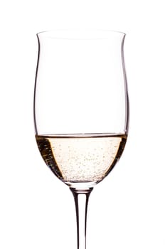 Carbonated white wine backlit in wine glass