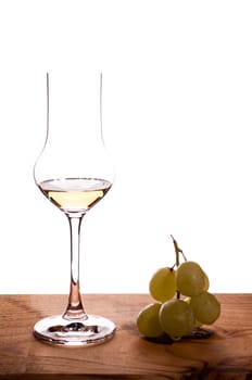 Italian grappa and grapes on a wooden board