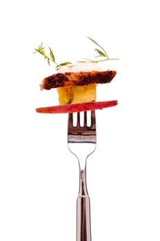 Isolated salad with chicken and fruit on a fork