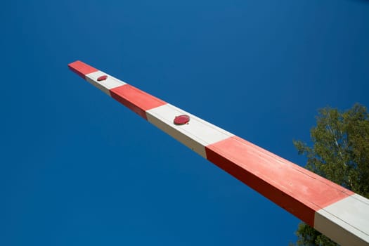 Red and white painted barrier is raised up