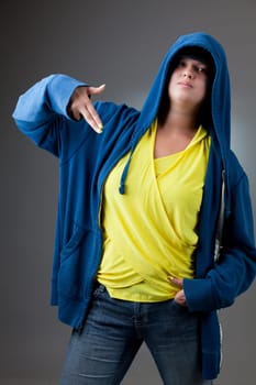 Studio portrait of a serious looking girl in a blue hooded jacket