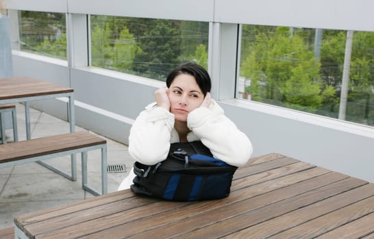 Outdoor portrait of a sad woman looking thoughtful about troubles