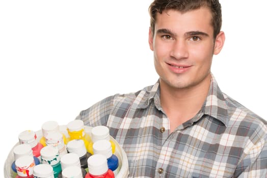 Young man with a paint bucket against white studio background