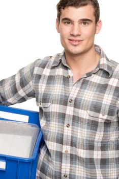 Young man with a blue box against a white studio background