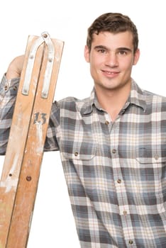 Young man leaning on a ladder against white studio background