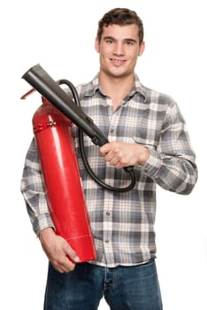 Young man with a fire extinguisher in front of a white studio background