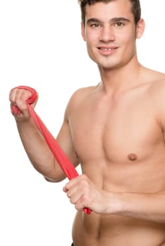 Young man with a red gymnastics band against a white studio background