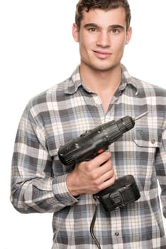 Young man with cordless screwdriver in front of white studio background