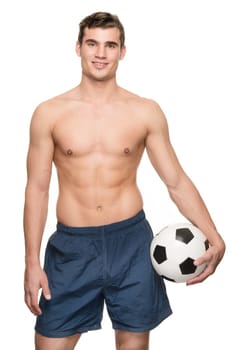 Young man with a soccer ball in front of white studio background