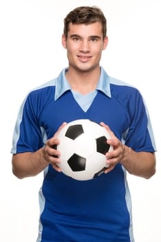 Young man with a soccer ball in front of white studio background