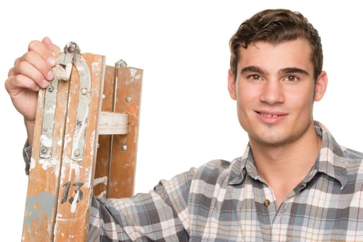 Young man leaning on a ladder against white studio background