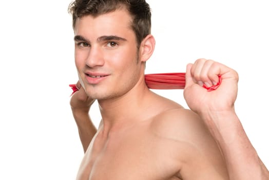 Young man with a red gymnastics band against a white studio background