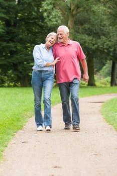 Attractive retired couple on a trip in a park