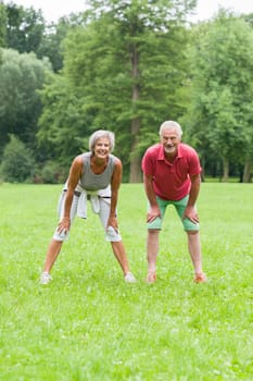 Active retired couple doing sports in a park
