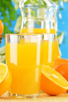 Composition with two glasses of orange juice and fruits