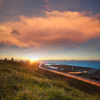 A road and windmills during sunset, made with a wide angle lens