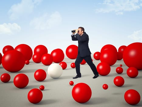 man with binoculars and 3d red balls world