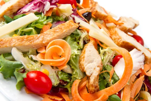 Chicken salad with fresh ingredients in the white bowl
