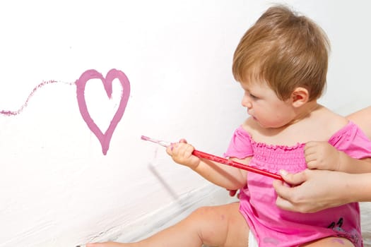Little girl paint on a board