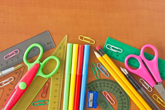 various school supplies on the wooden table