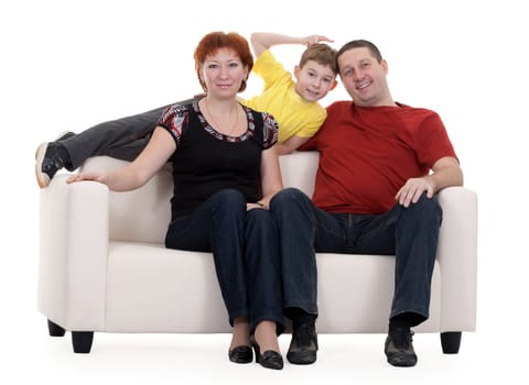 family with son sitting on a sofa on a white background