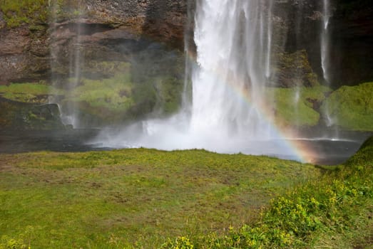 Seljalandsfoss waterfall with rainbow in Iceland
