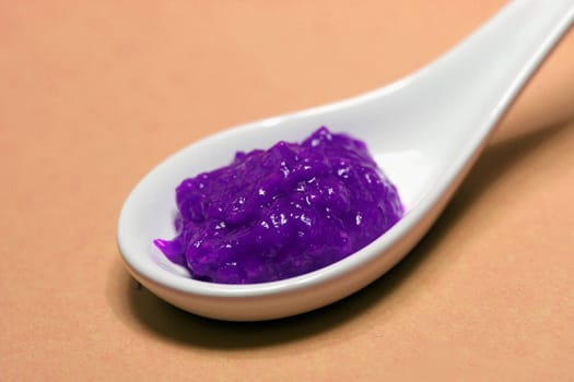 poisoned colored spice on a porcelain spoon