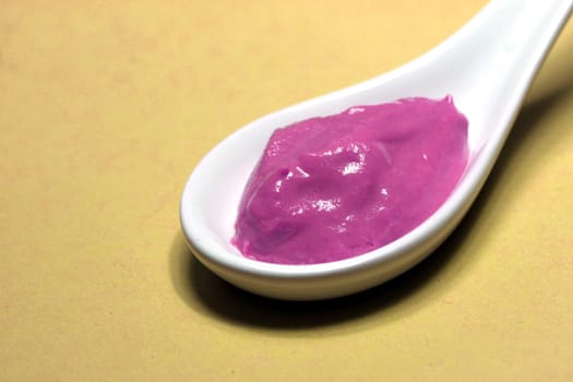 poisoned colored spice on a porcelain spoon