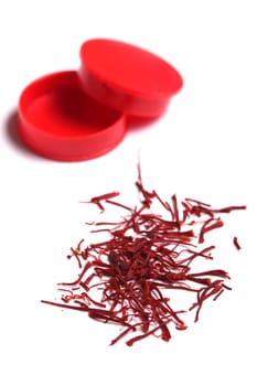 saffron threads in a red beverage