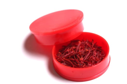 saffron threads in a red beverage