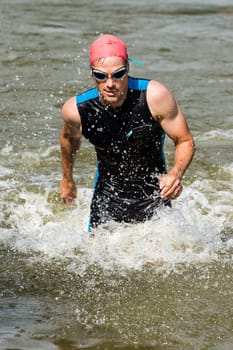 Triathlete runs out of the water