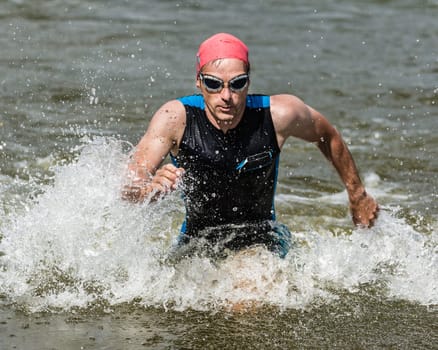 Triathlete runs out of the water
