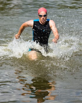 Triathlete runs out of the water