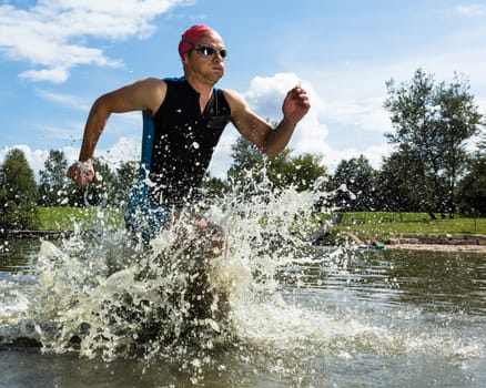 Triathlete runs out of the water