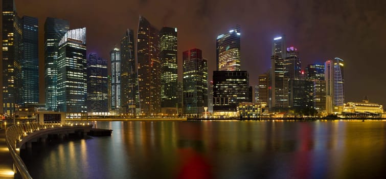 Singapore Downtown City Skyline at the Marina along the River at Night with Water Reflection