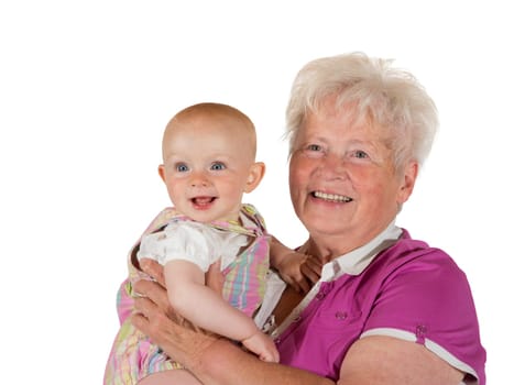 The joy of being a grandmother, a beaming, joful young baby and doting grandmother smile happily for the camera while posing for a studio portrait