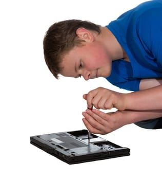 Man leaning over the bottom of his opened laptop doing home repairs or upgrades to hardware