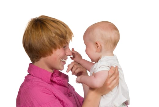 Cute young baby looking away from the camera gently touching the nose of its happy smiling mother