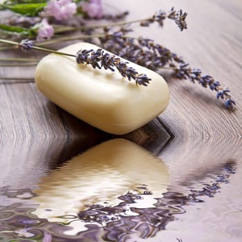 lanvander soap with flower on wooden background