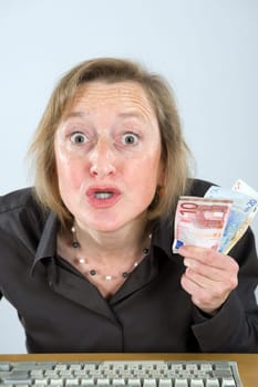 angry woman with money in the office